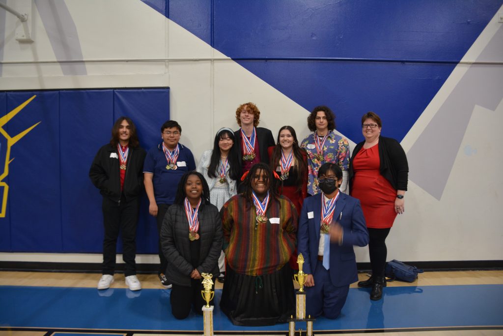 The WISH Academy Academic Decathlon team poses with their trophies at a competition gathering in February 2024.